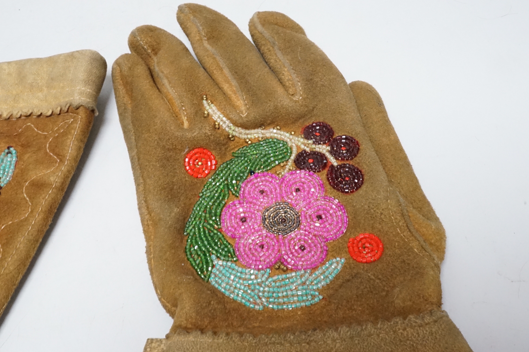 A pair of early 20th century native American suede and beaded gauntlet gloves, 39cm long